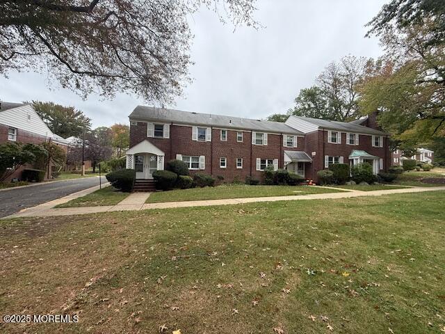 82 Manor Drive, Unit 803 Red Bank, NJ 07701 - Photo 38 of 39 a front view of a house with a yard