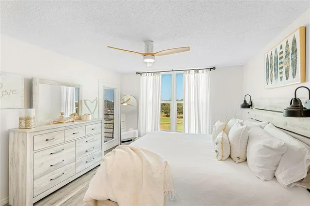 a bedroom with a large bed and a dresser