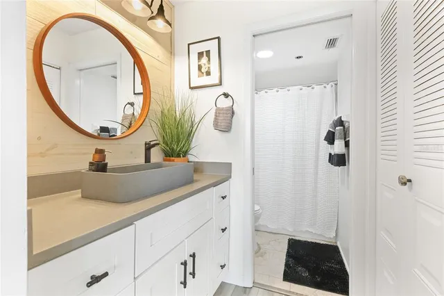 a bathroom with a sink a vanity and a mirror