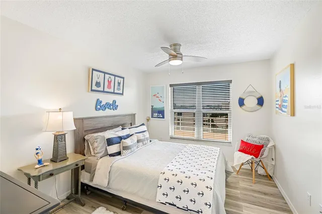 a bedroom with a bed dresser and a window