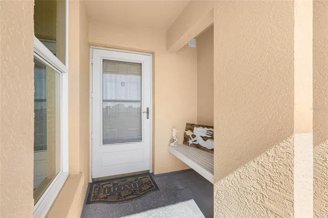 a view of a hallway with wooden floor and a living room