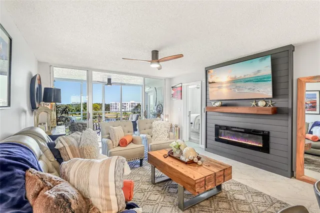 a living room with furniture a fireplace and a flat screen tv