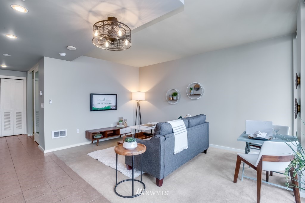76 Cedar Street, Unit 910 Seattle, WA 98121 - Photo 11 of 30 a living room with furniture and a chandelier