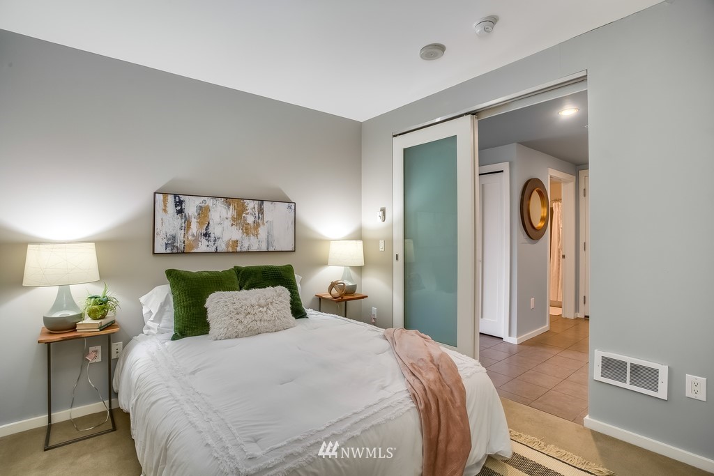 76 Cedar Street, Unit 910 Seattle, WA 98121 - Photo 12 of 30 a bedroom with a bed and a lamp