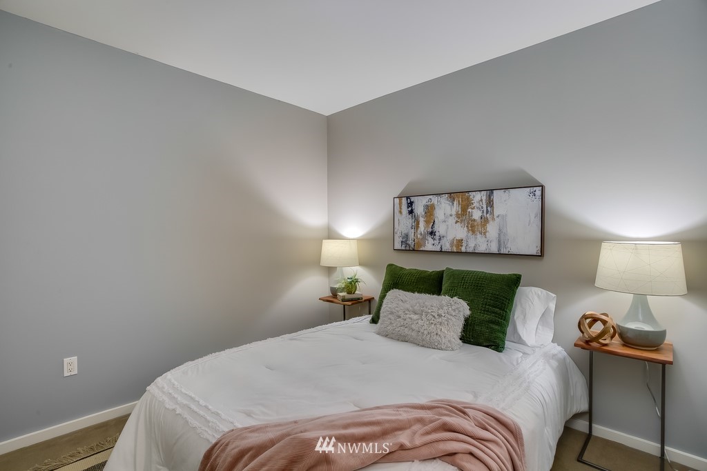 76 Cedar Street, Unit 910 Seattle, WA 98121 - Photo 13 of 30 a bedroom with a bed and a lamp on dresser