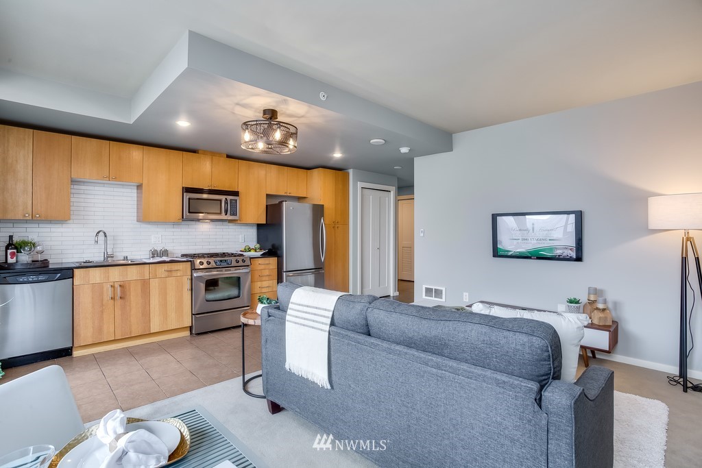 76 Cedar Street, Unit 910 Seattle, WA 98121 - Photo 15 of 30 a living room with stainless steel appliances furniture and a kitchen view
