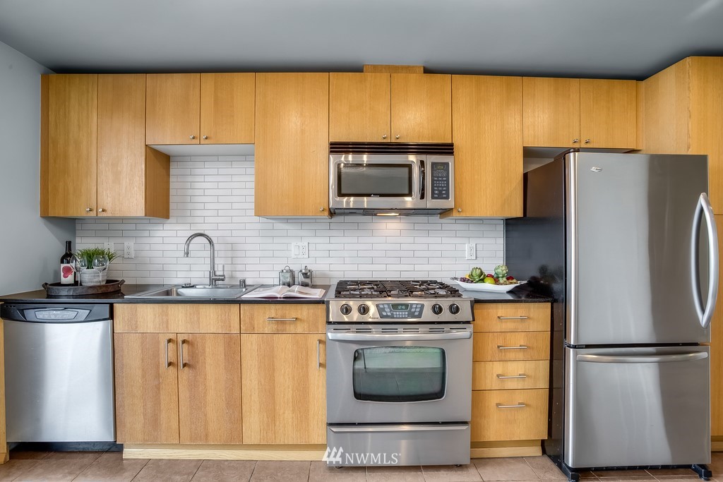 76 Cedar Street, Unit 910 Seattle, WA 98121 - Photo 16 of 30 a kitchen with a refrigerator stove and microwave