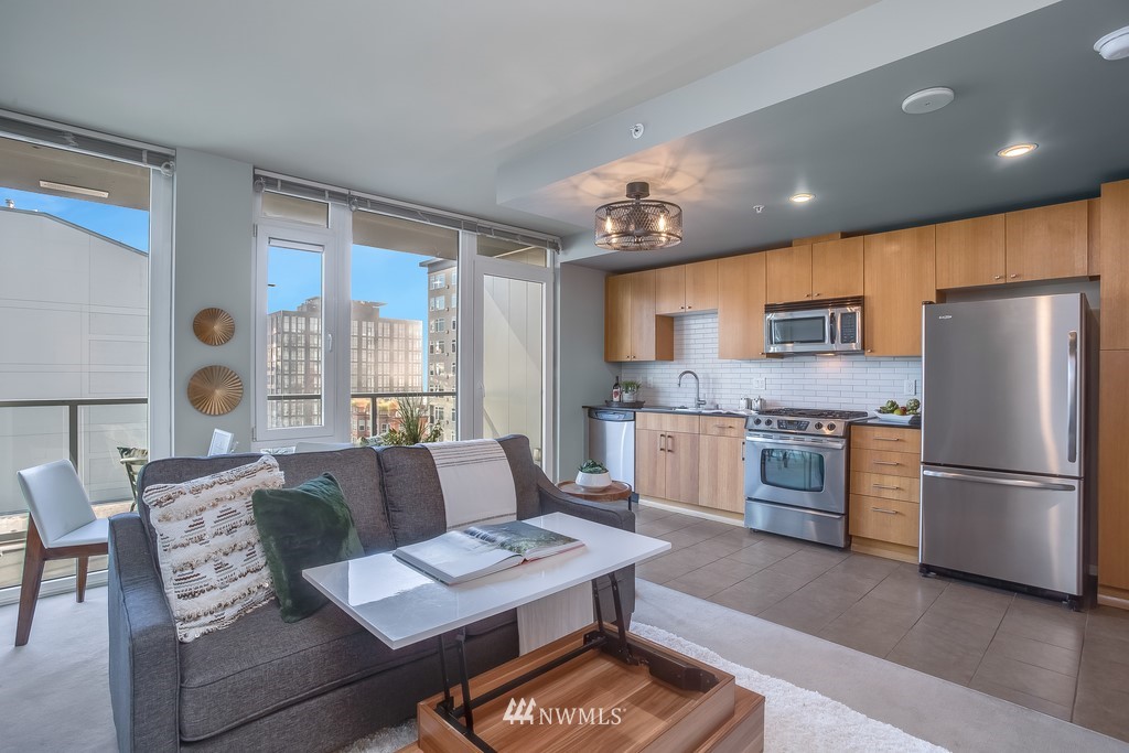 76 Cedar Street, Unit 910 Seattle, WA 98121 - Photo 5 of 30 a living room with stainless steel appliances furniture and a kitchen view