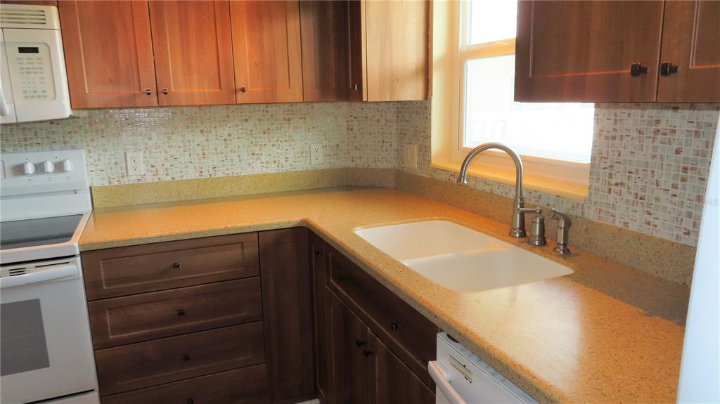 2295 Americus Boulevard East, Unit 29 Clearwater, FL 33763 - Photo 13 of 39 a kitchen with a sink and cabinets