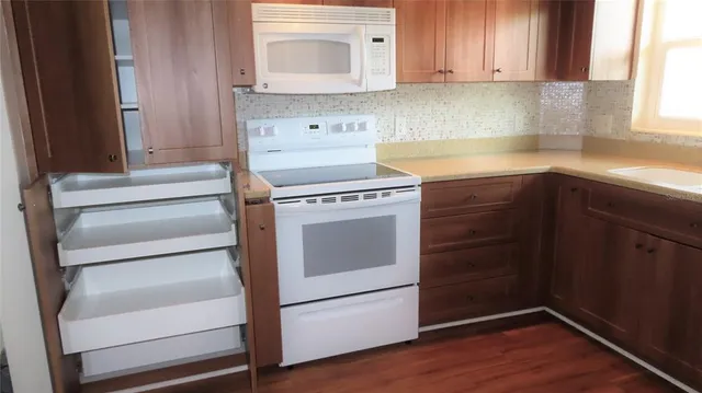 a kitchen with a sink stove and cabinets