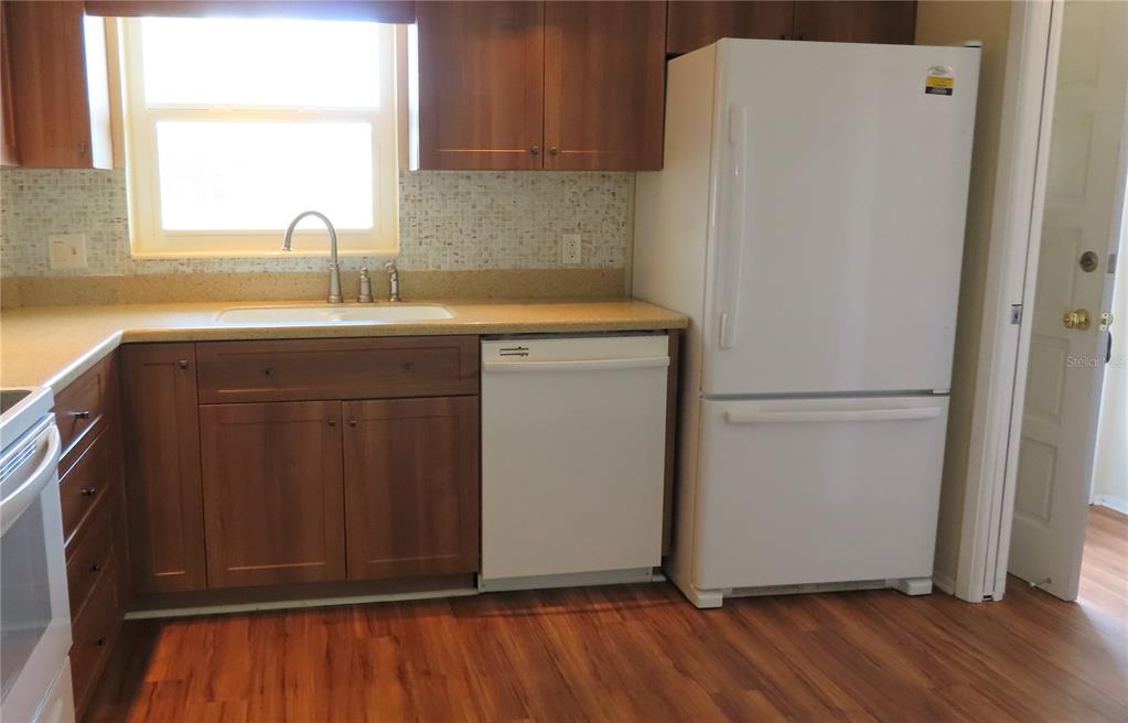 2295 Americus Boulevard East, Unit 29 Clearwater, FL 33763 - Photo 19 of 39 a kitchen with a refrigerator sink and cabinets
