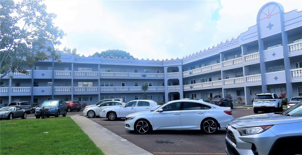 2295 Americus Boulevard East, Unit 29 Clearwater, FL 33763 - Photo 2 of 39 a front view of a building with parking space