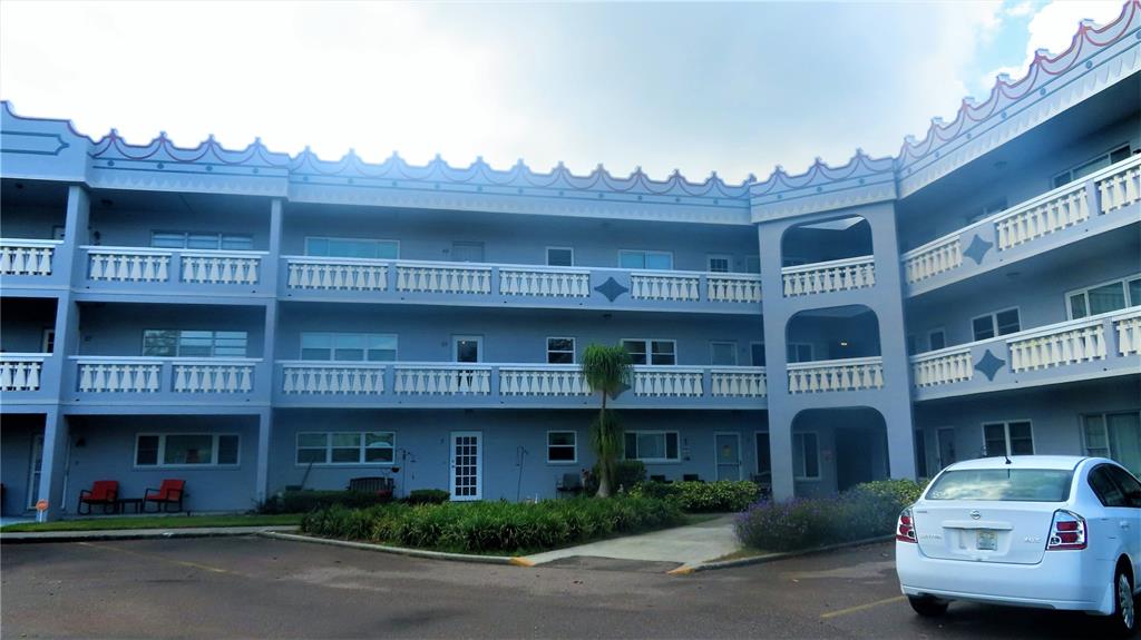 2295 Americus Boulevard East, Unit 29 Clearwater, FL 33763 - Photo 3 of 39 a front view of a building with many windows