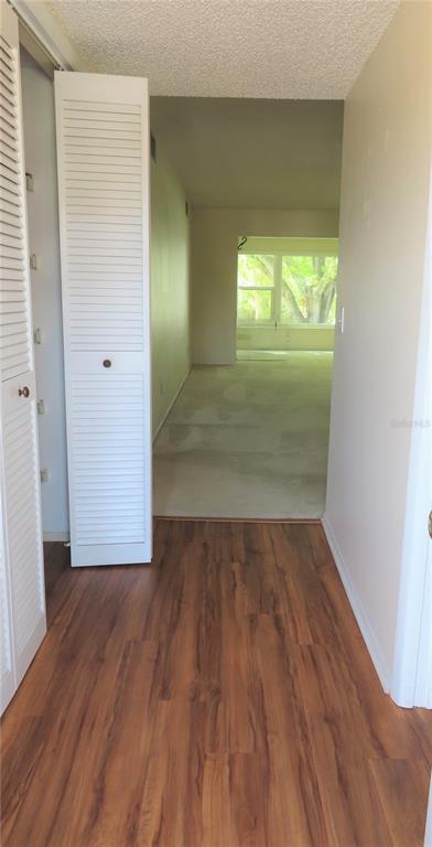 2295 Americus Boulevard East, Unit 29 Clearwater, FL 33763 - Photo 6 of 39 a view of empty room with wooden floor