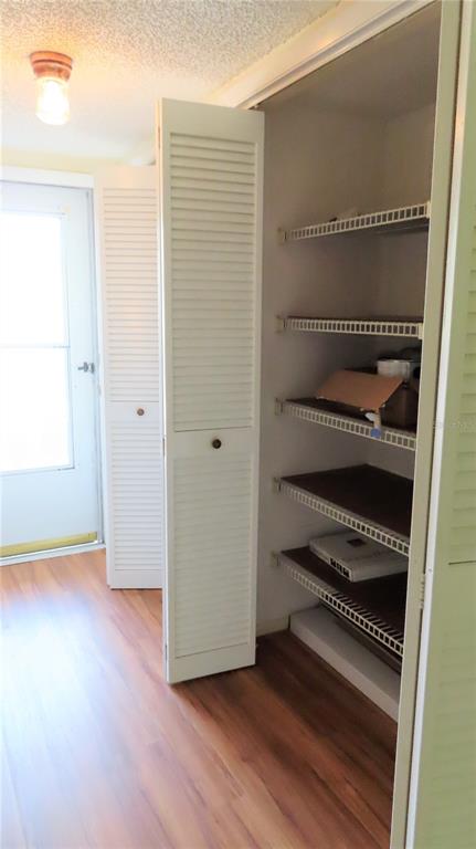 2295 Americus Boulevard East, Unit 29 Clearwater, FL 33763 - Photo 7 of 39 a view of a room with wooden floor