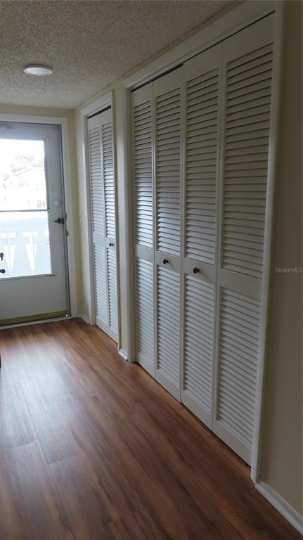 2295 Americus Boulevard East, Unit 29 Clearwater, FL 33763 - Photo 8 of 39 an empty room with wooden floor and windows