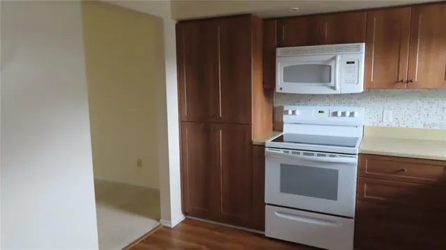 a white refrigerator freezer sitting inside of a kitchen