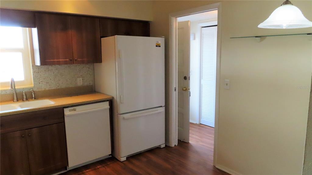 2295 Americus Boulevard East, Unit 29 Clearwater, FL 33763 - Photo 10 of 39 a white refrigerator freezer sitting inside of a kitchen