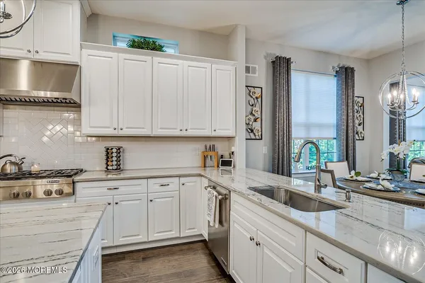 a bathroom with a double vanity sink mirror and shower