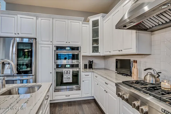 a bathroom with a granite countertop sink double and mirror