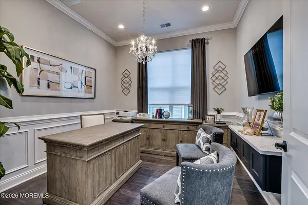 a living room with furniture or wooden floor and a view of kitchen