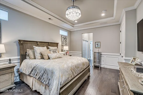 a bedroom with a bed and a chandelier