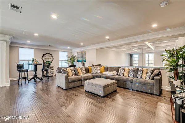 a living room with furniture a flat screen tv and a table