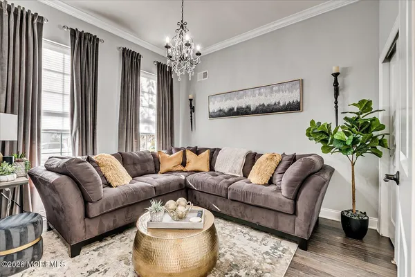 a living room with lots of furniture and view of kitchen