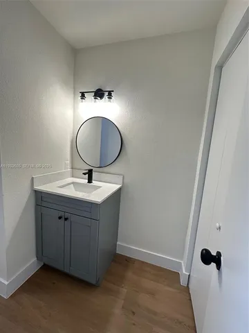 a bathroom with a sink vanity and mirror