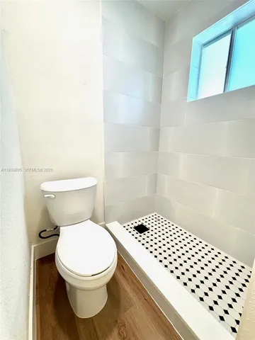 a white toilet sitting next to a bathroom sink