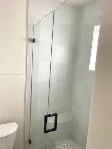 a bathroom with a shower and toilet