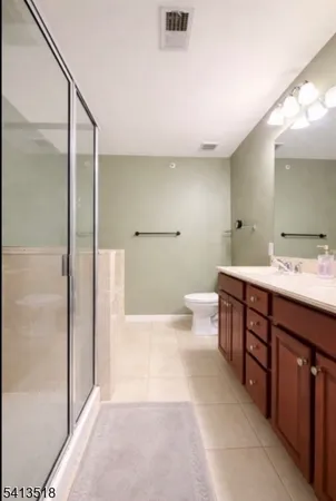 a spacious bathroom with a bathtub shower sink mirror and toilet