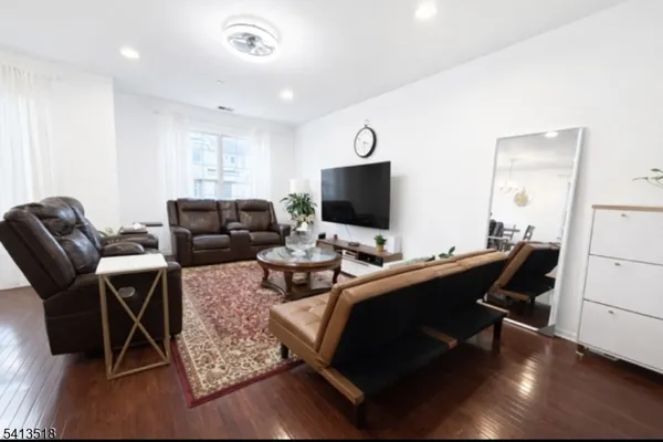 a view of a workspace with furniture and wooden floor