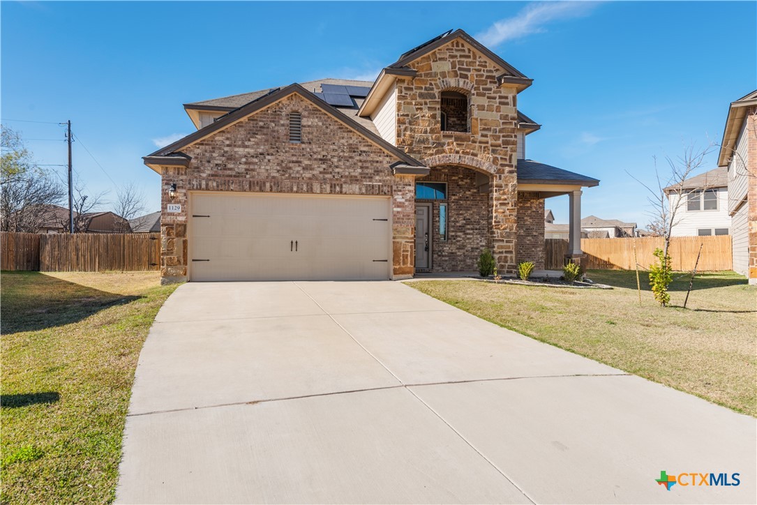 1129 Ibis Falls Loop Jarrell, TX 76537 - Photo 2 of 39 a front view of a house with a yard