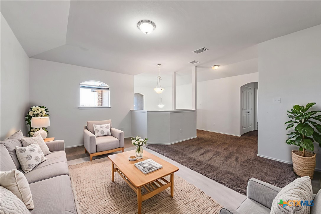 1129 Ibis Falls Loop Jarrell, TX 76537 - Photo 24 of 39 a living room with furniture and wooden floor