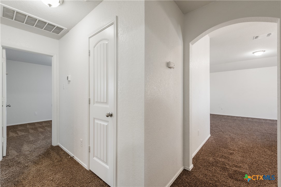 1129 Ibis Falls Loop Jarrell, TX 76537 - Photo 32 of 39 a view of a hallway with wooden floor