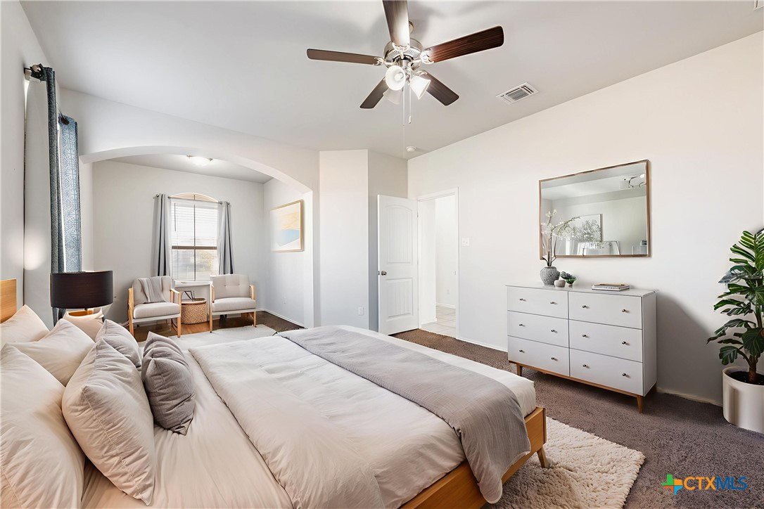 1129 Ibis Falls Loop Jarrell, TX 76537 - Photo 8 of 39 a bedroom with a bed and a dresser