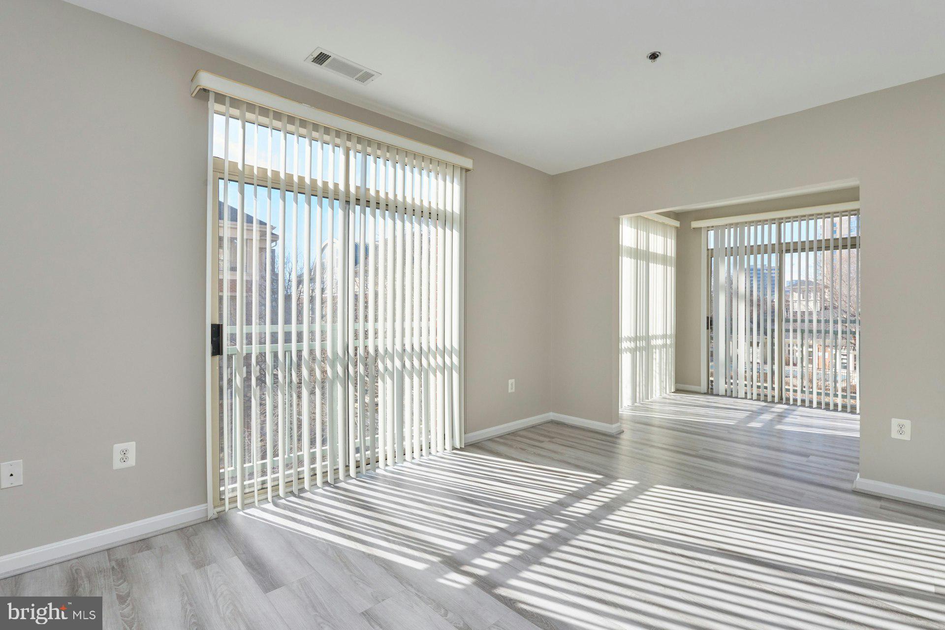1851 Stratford Park Place, Unit 212 Reston, VA 20190 - Photo 11 of 39 a view of a room with wooden floor and windows
