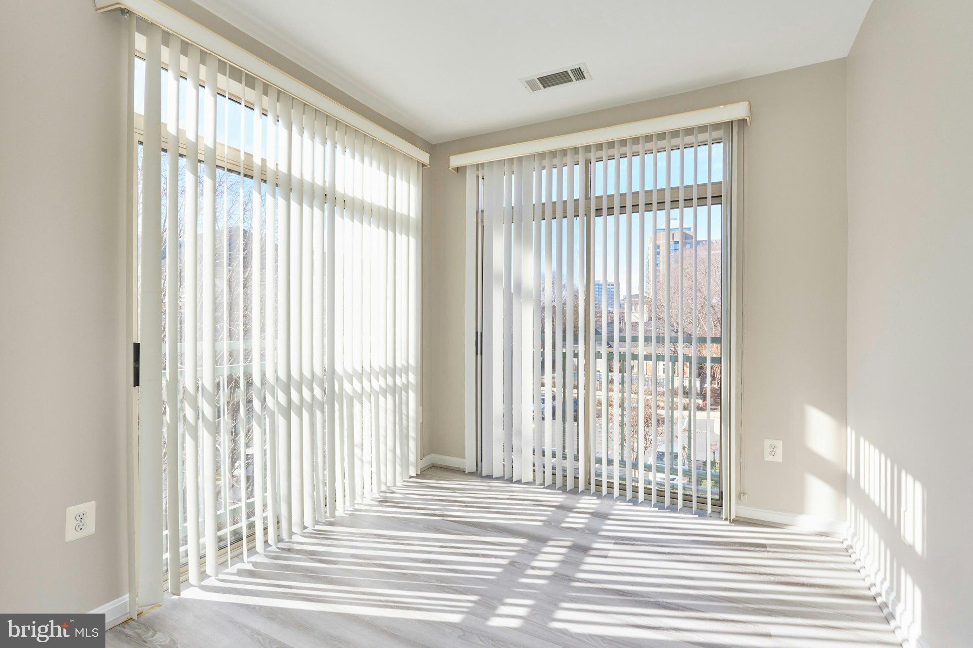1851 Stratford Park Place, Unit 212 Reston, VA 20190 - Photo 12 of 39 a view of a room with a wooden floor and a window