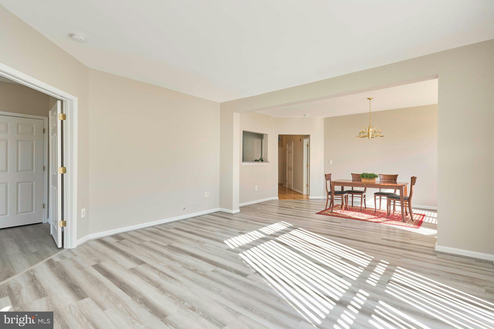 1851 Stratford Park Place, Unit 212 Reston, VA 20190 - Photo 12 of 40 a bedroom with a bed and a table