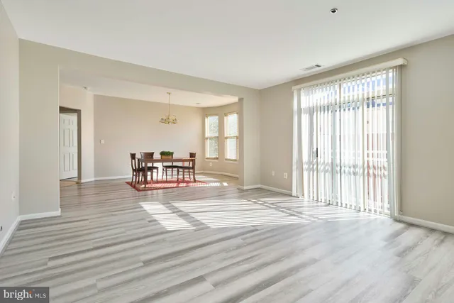 a room with wooden floor and furniture