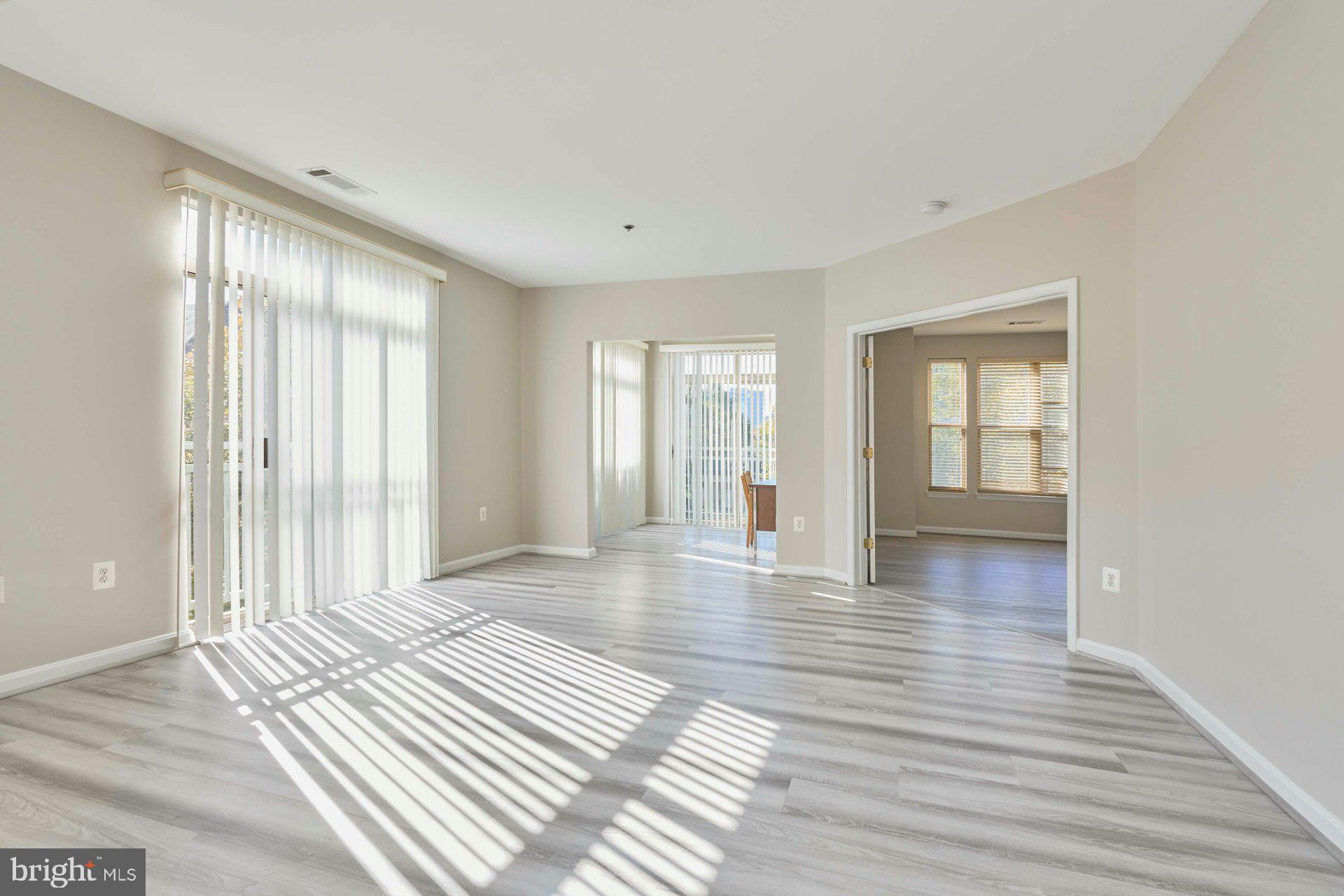 1851 Stratford Park Place, Unit 212 Reston, VA 20190 - Photo 14 of 40 a view of a room with wooden floor and window