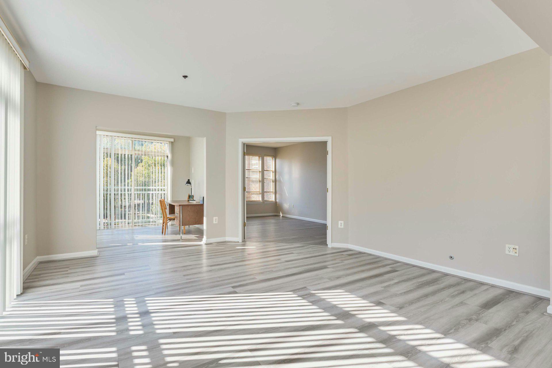 1851 Stratford Park Place, Unit 212 Reston, VA 20190 - Photo 15 of 40 a view of empty room with wooden floor and fan