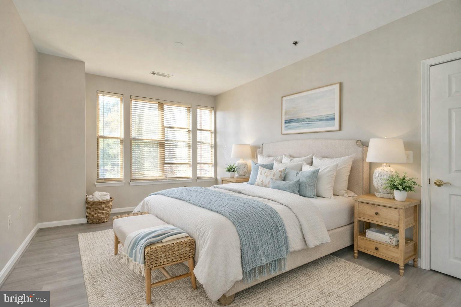 1851 Stratford Park Place, Unit 212 Reston, VA 20190 - Photo 17 of 39 a bedroom with a bed and a painting on the wall