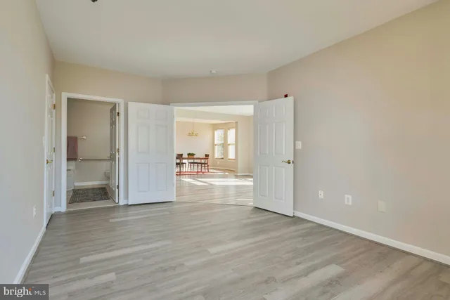 a view of a room with wooden floor