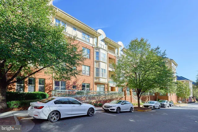 a city street lined with parked cars and buildings