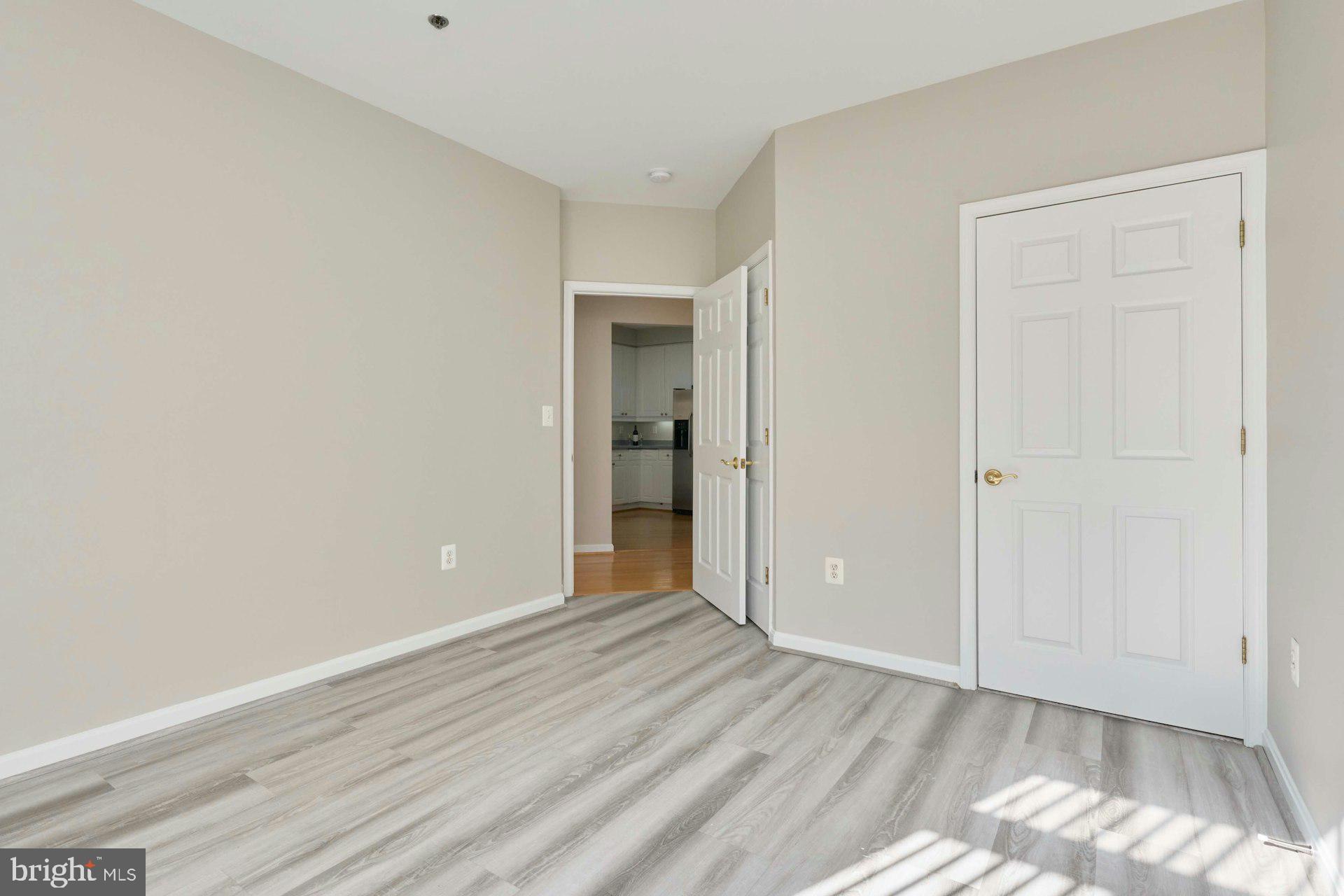 1851 Stratford Park Place, Unit 212 Reston, VA 20190 - Photo 22 of 39 a view of an empty room with wooden floor