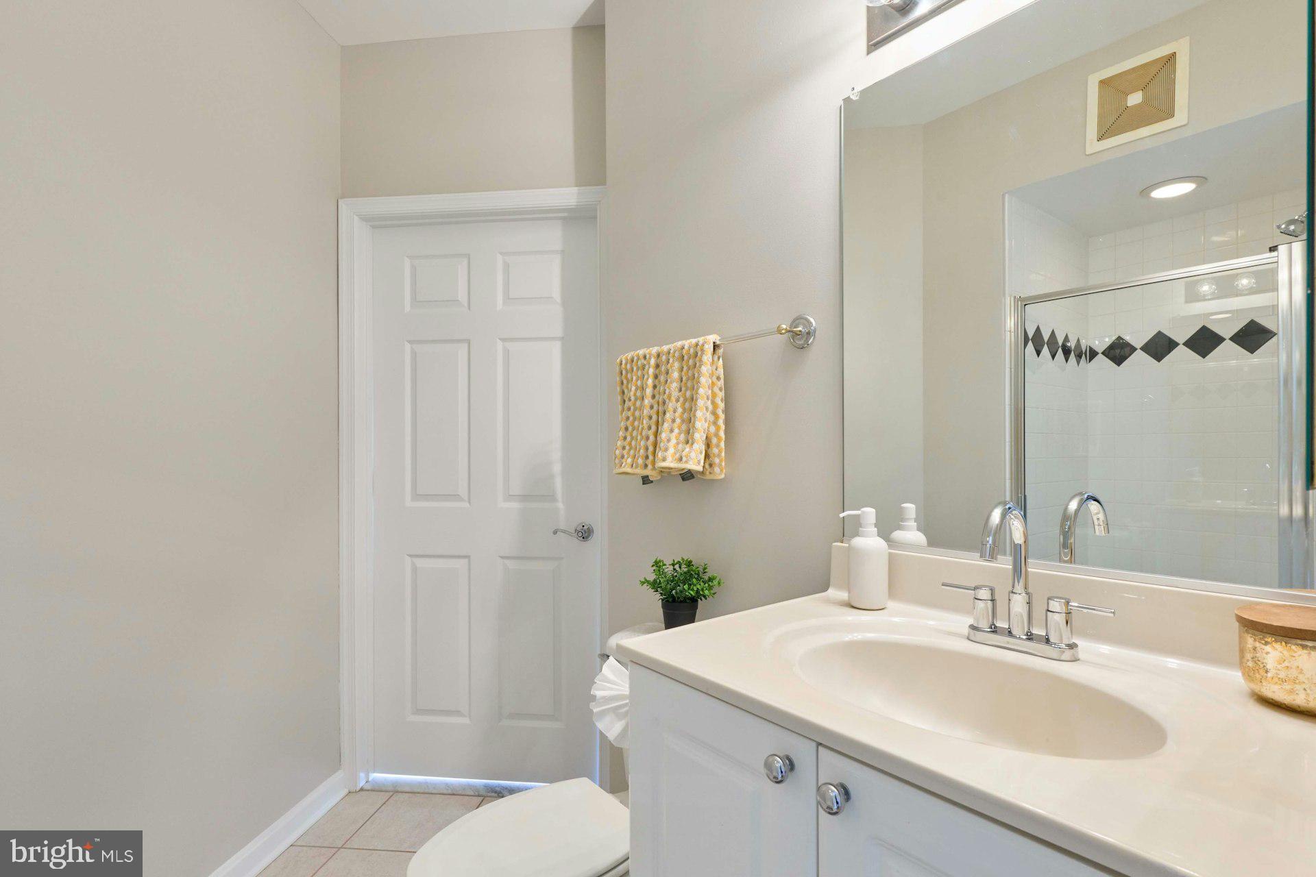 1851 Stratford Park Place, Unit 212 Reston, VA 20190 - Photo 23 of 39 a bathroom with a sink toilet and vanity