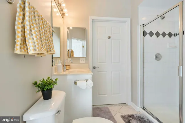 a bathroom with a toilet shower and a sink