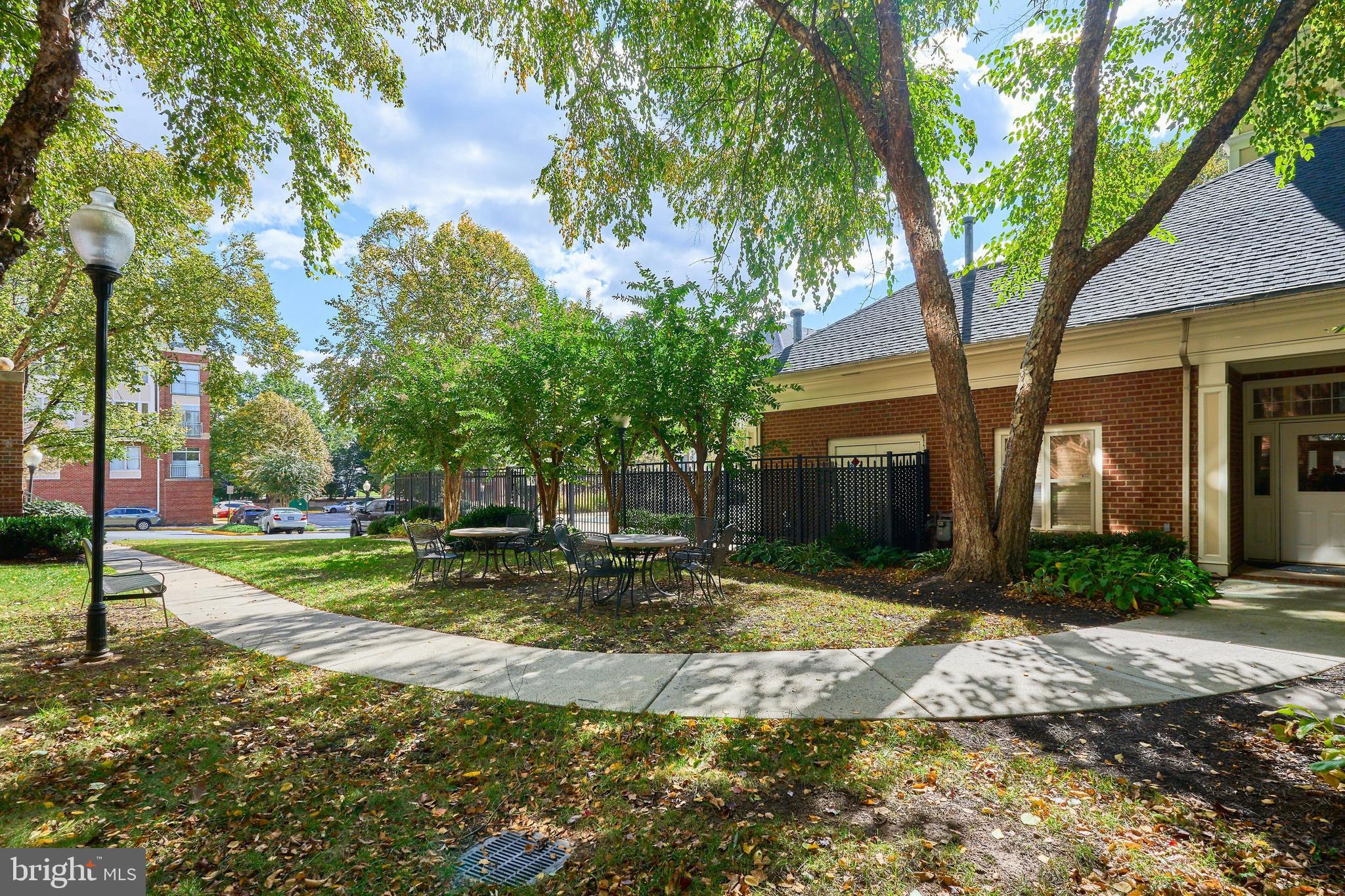 1851 Stratford Park Place, Unit 212 Reston, VA 20190 - Photo 26 of 39 a view of a yard with plants and trees